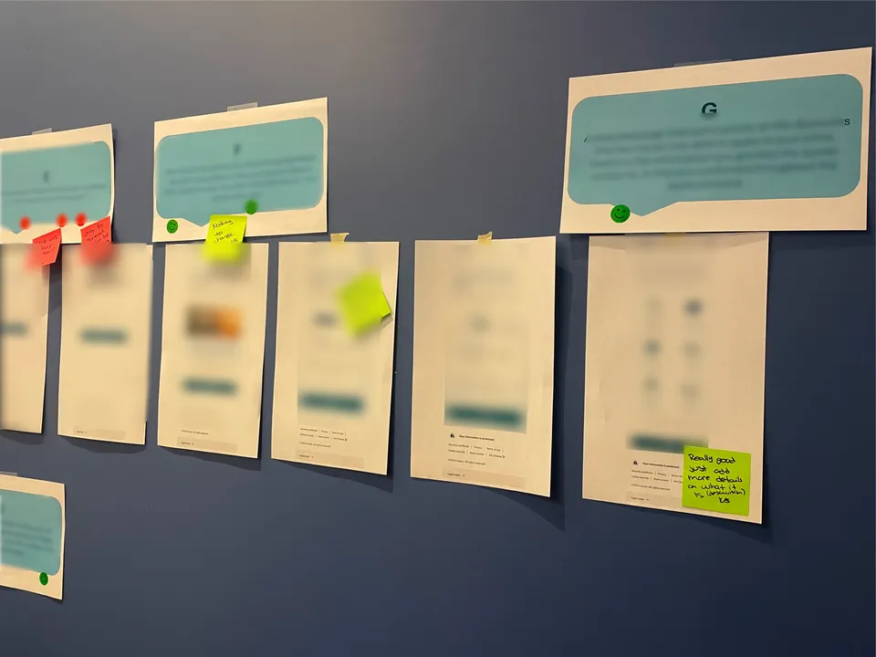 Printed quote screens on the blue wall, blurred, with sticky note feedback from participants